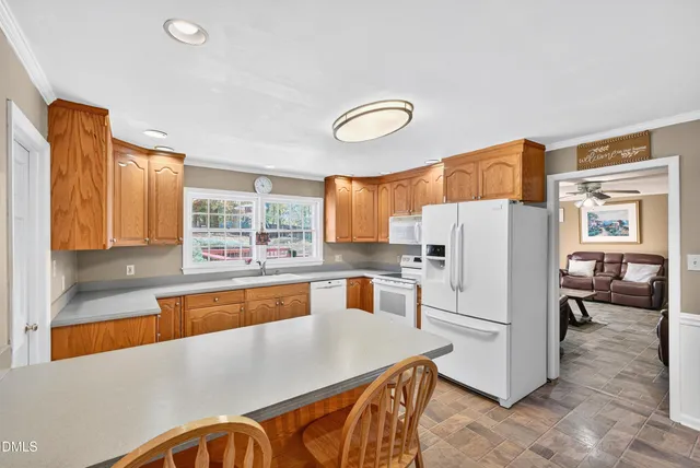 a kitchen with stainless steel appliances a refrigerator and a stove top oven
