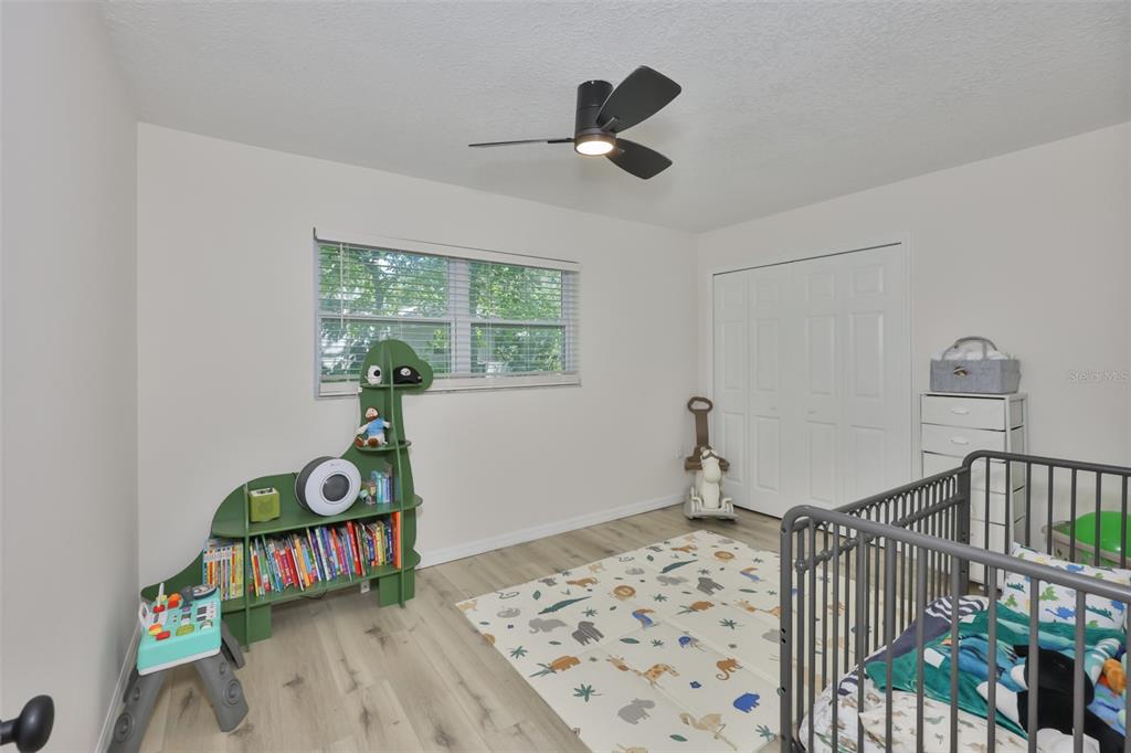 1578 Indian Bay Road Spring Hill, FL 34607 - Photo 32 of 51 a bedroom with furniture and a window