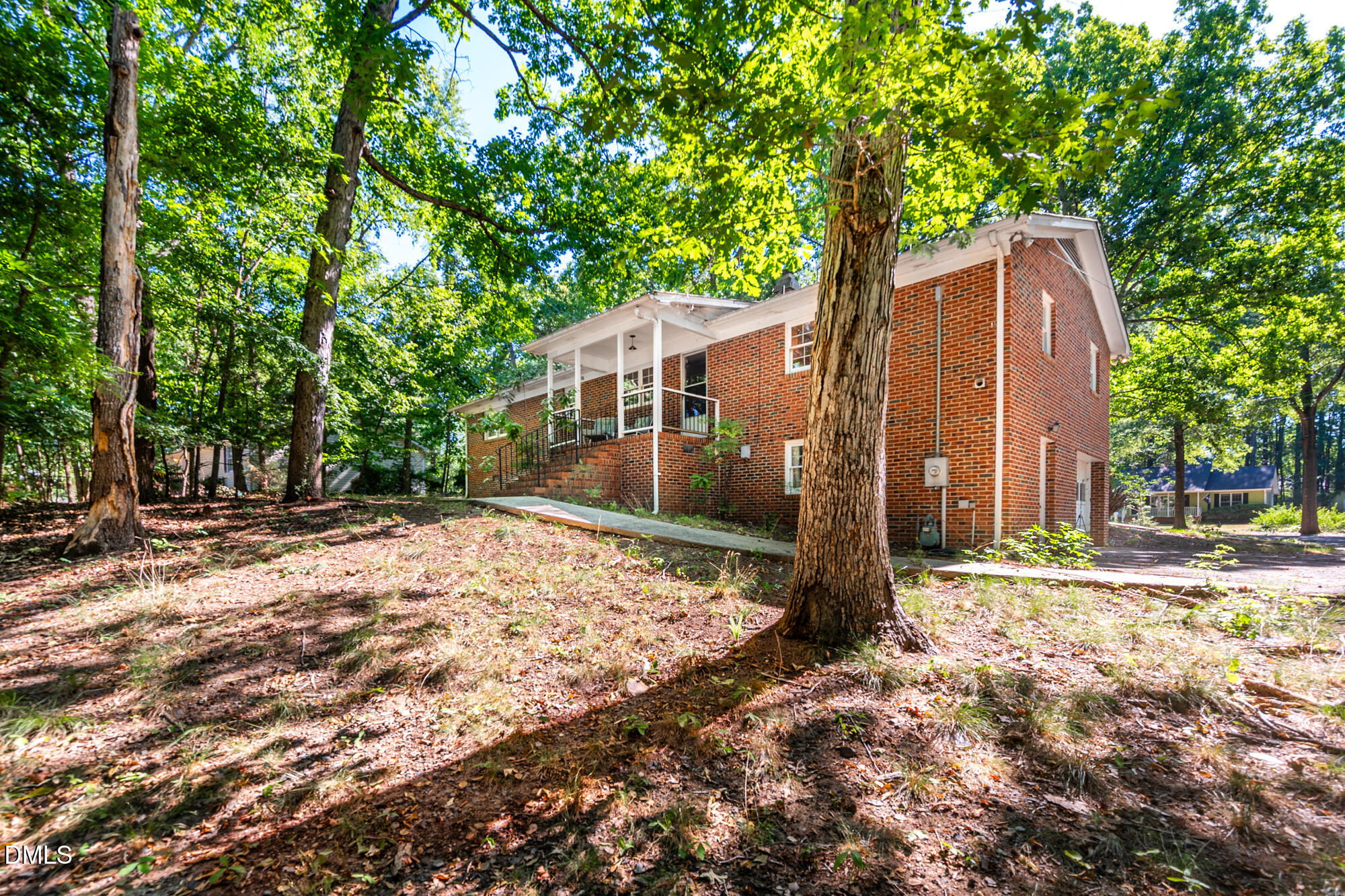 4411 Rhew Drive Durham, NC 27704 - Photo 33 of 34 a backyard of a house with large trees and wooden fence