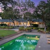 a swimming pool with outdoor seating and yard