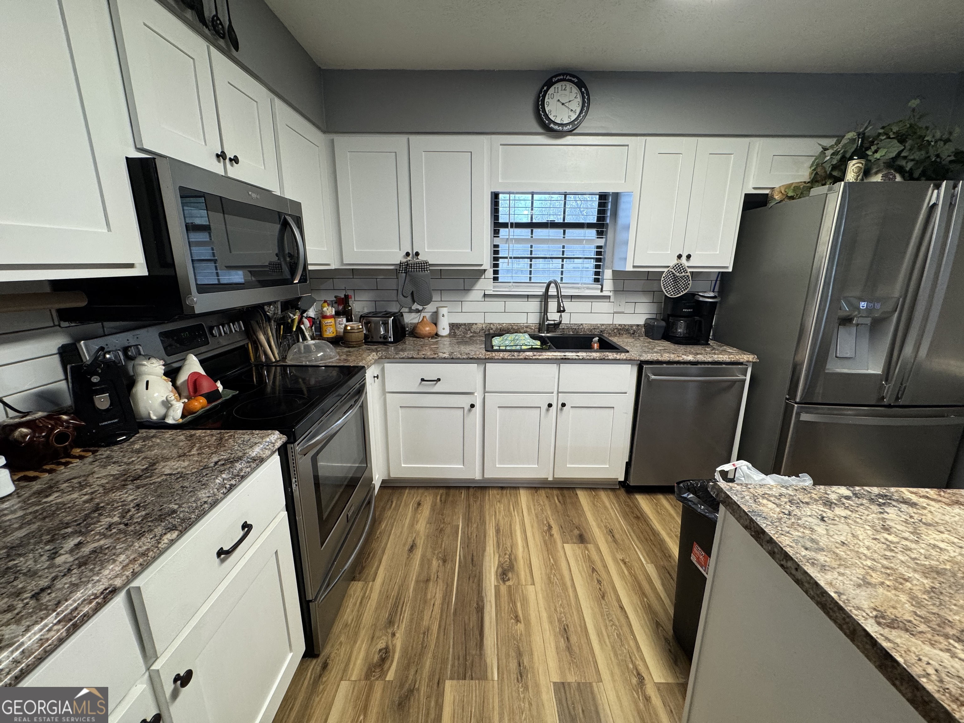 509 Lakeview Drive Dexter, GA 31019 - Photo 14 of 41 a kitchen with a sink a stove and cabinets