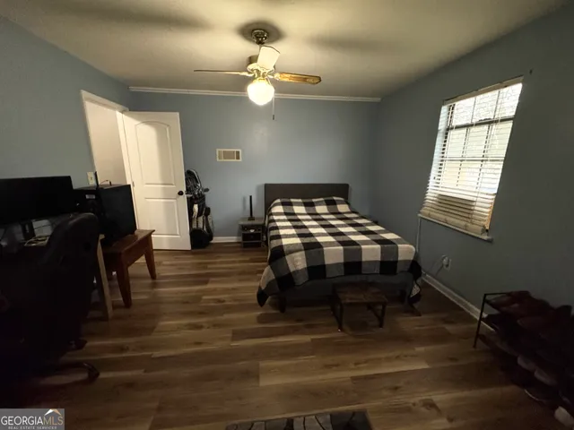 a bedroom with furniture and a window