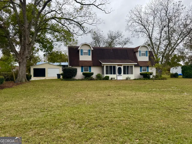 a front view of a house with a garden