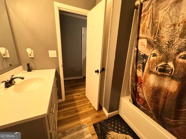 a bathroom with a tub and shower