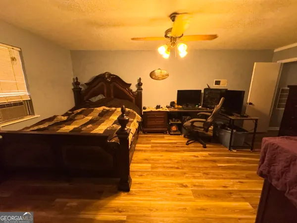 a bed sitting in a bedroom next to a window