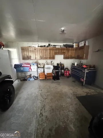 a living room with lots of furniture and a view of bedroom