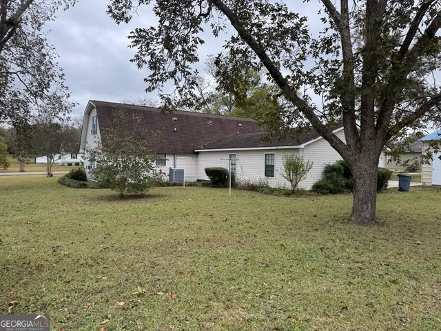 a view of a house with yard and sitting area