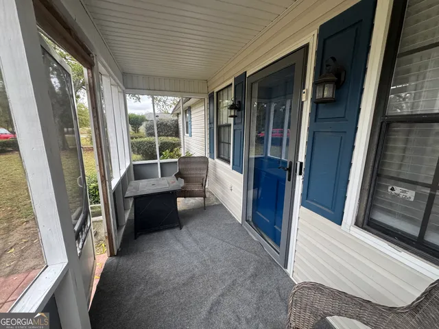 a living room with furniture and a balcony