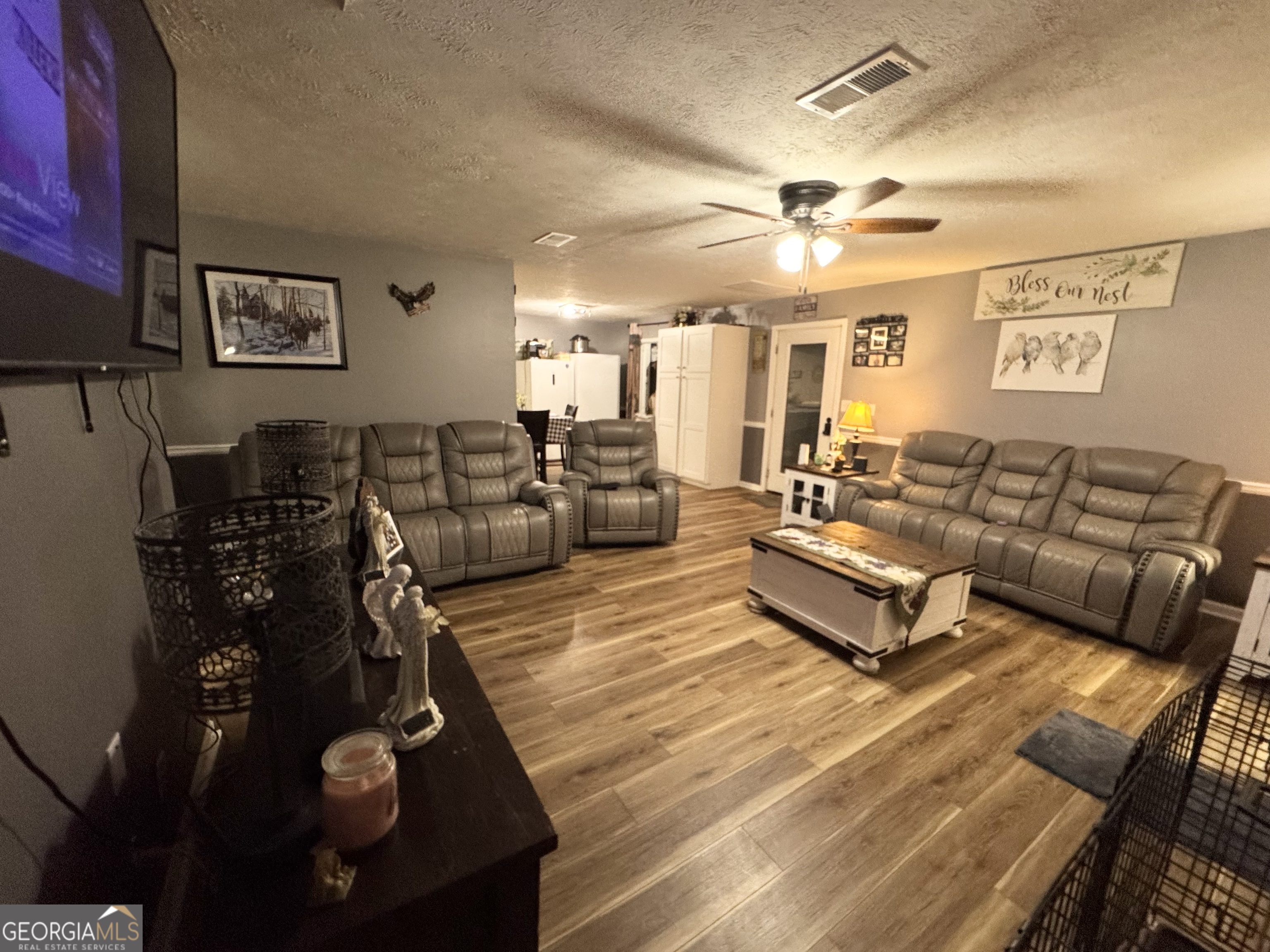 509 Lakeview Drive Dexter, GA 31019 - Photo 9 of 41 a living room with furniture a large window and gym equipment