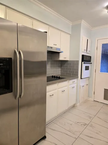 a kitchen with stainless steel appliances cabinets and a counter top space