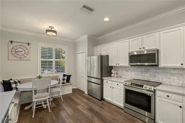 a kitchen with stainless steel appliances a stove a sink refrigerator and microwave