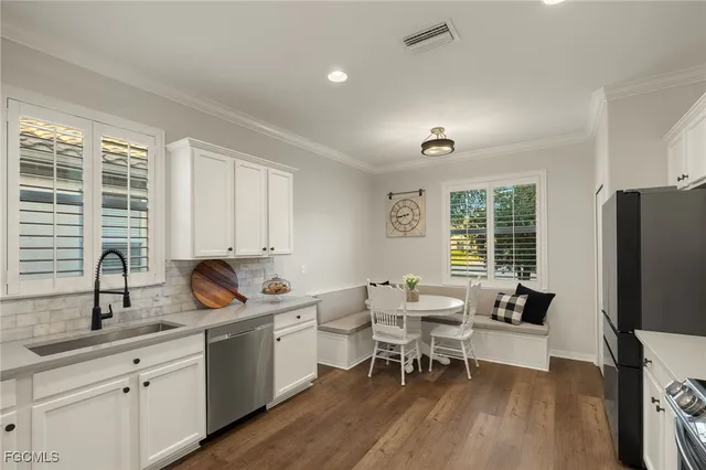 a view of a kitchen with a sink and a refrigerator