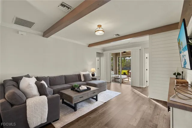 a living room with furniture and wooden floor