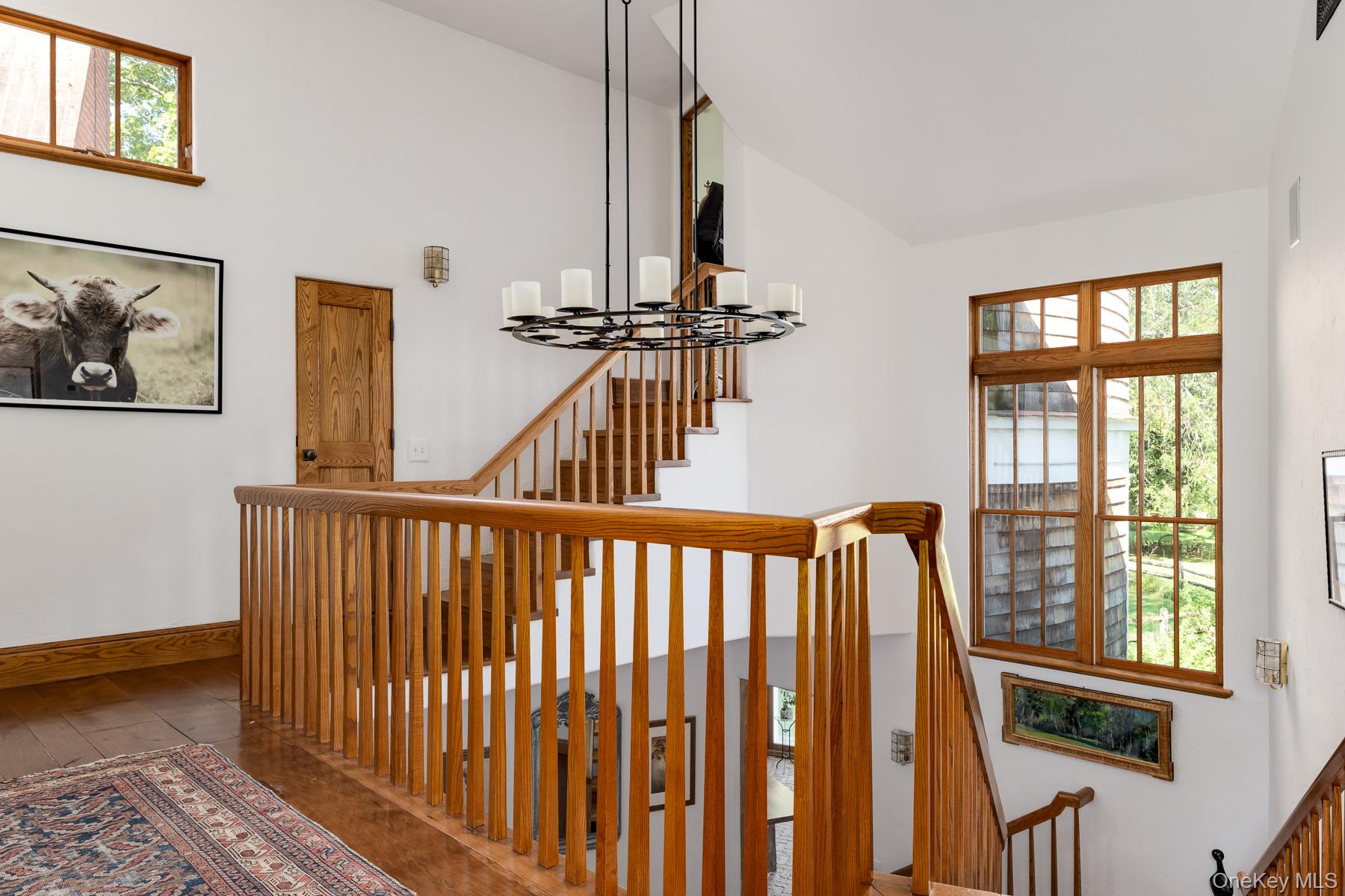 11 Carriage House Road Waccabuc, NY 10597 - Photo 19 of 39 a view of hallway with stairs and wooden floor