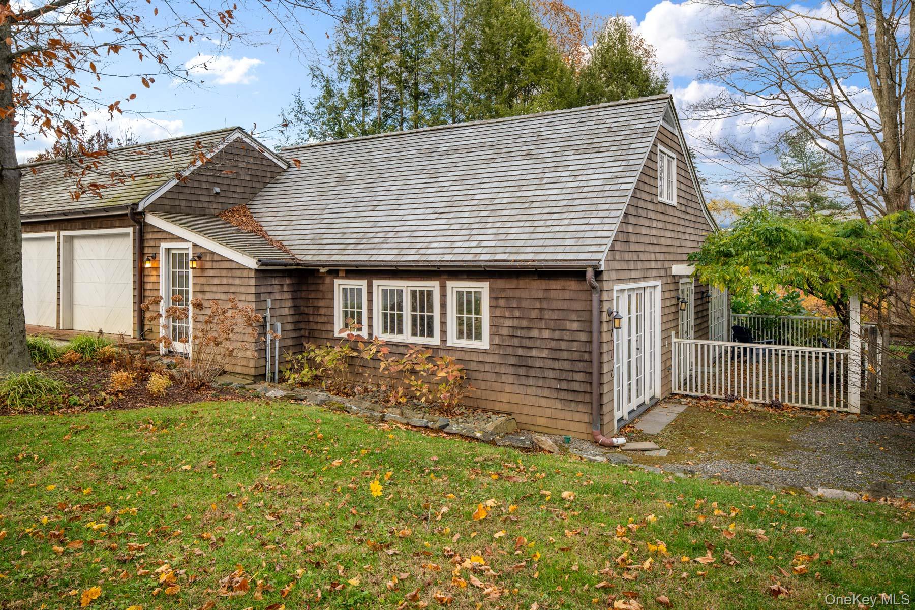 11 Carriage House Road Waccabuc, NY 10597 - Photo 25 of 39 a front view of a house with a garden