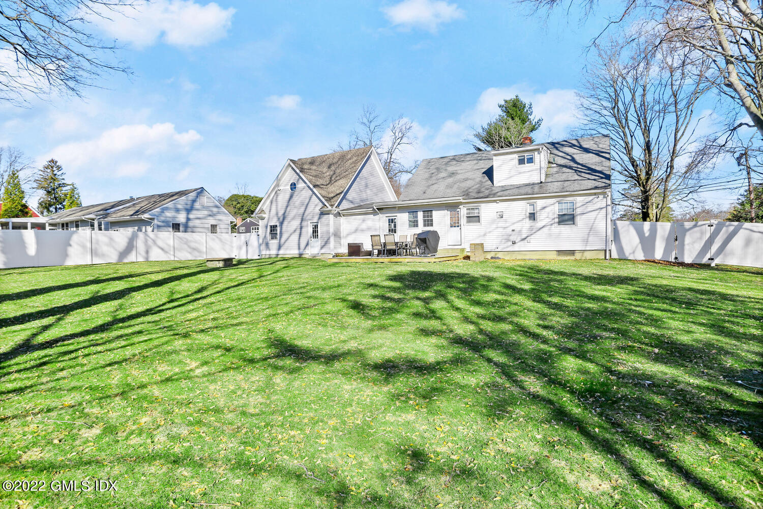 16 Esquire Road Norwalk, CT 06851 - Photo 28 of 33 a white house with a small yard and large trees