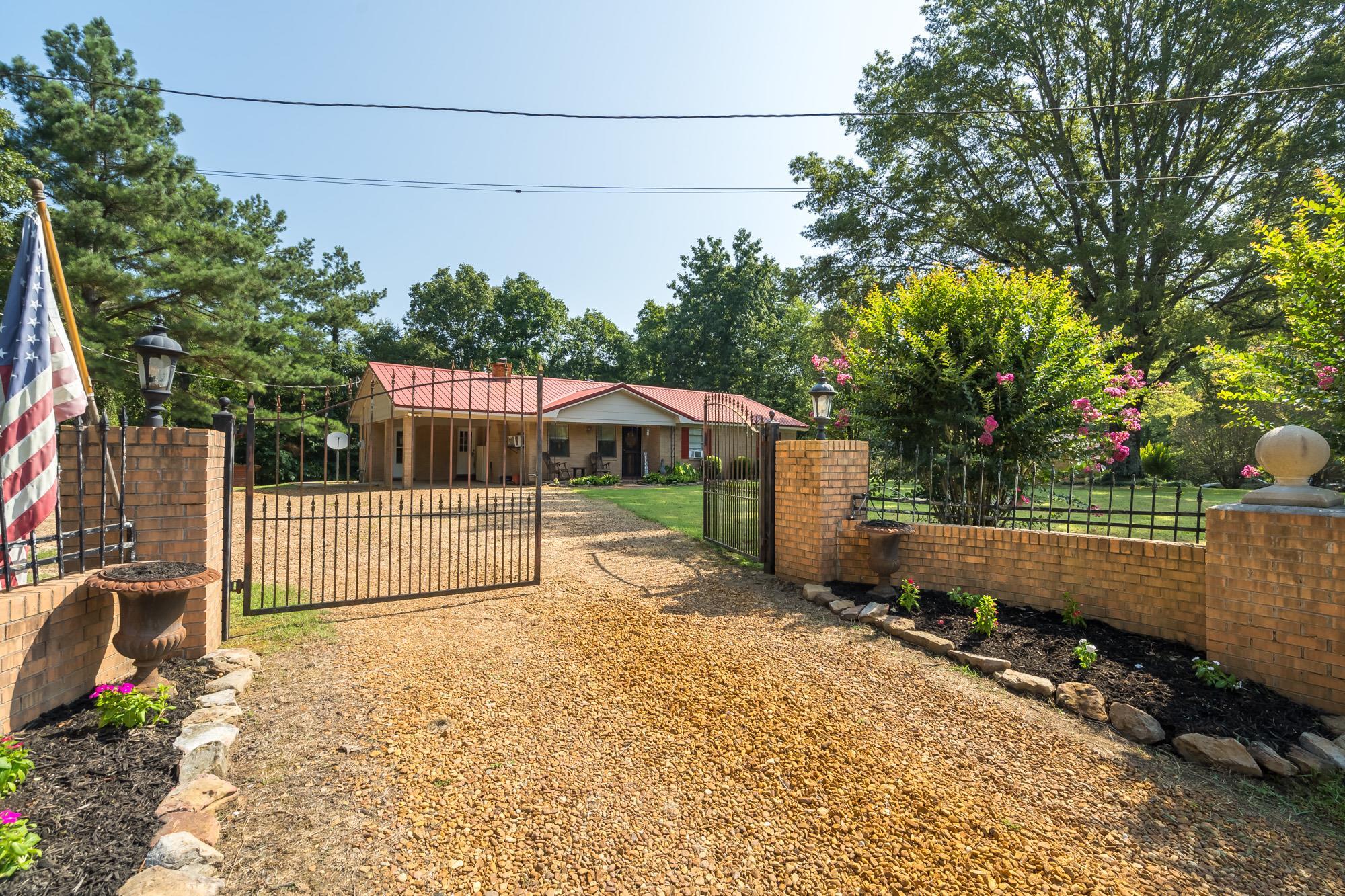 2484 Bryan Road Michigan City, MS 38647 - Photo 1 of 31 a view of a backyard with wooden fence and a bench