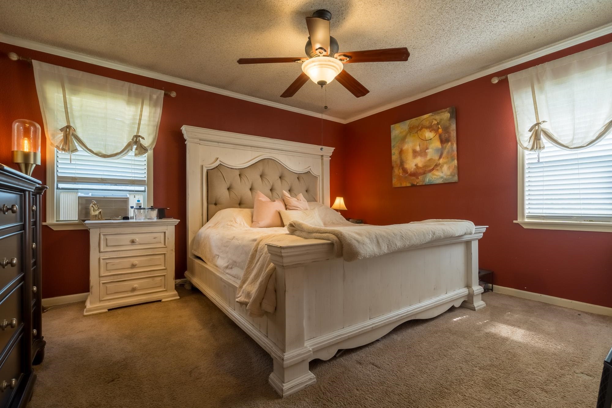 2484 Bryan Road Michigan City, MS 38647 - Photo 23 of 31 a bedroom with a bed and a chandelier