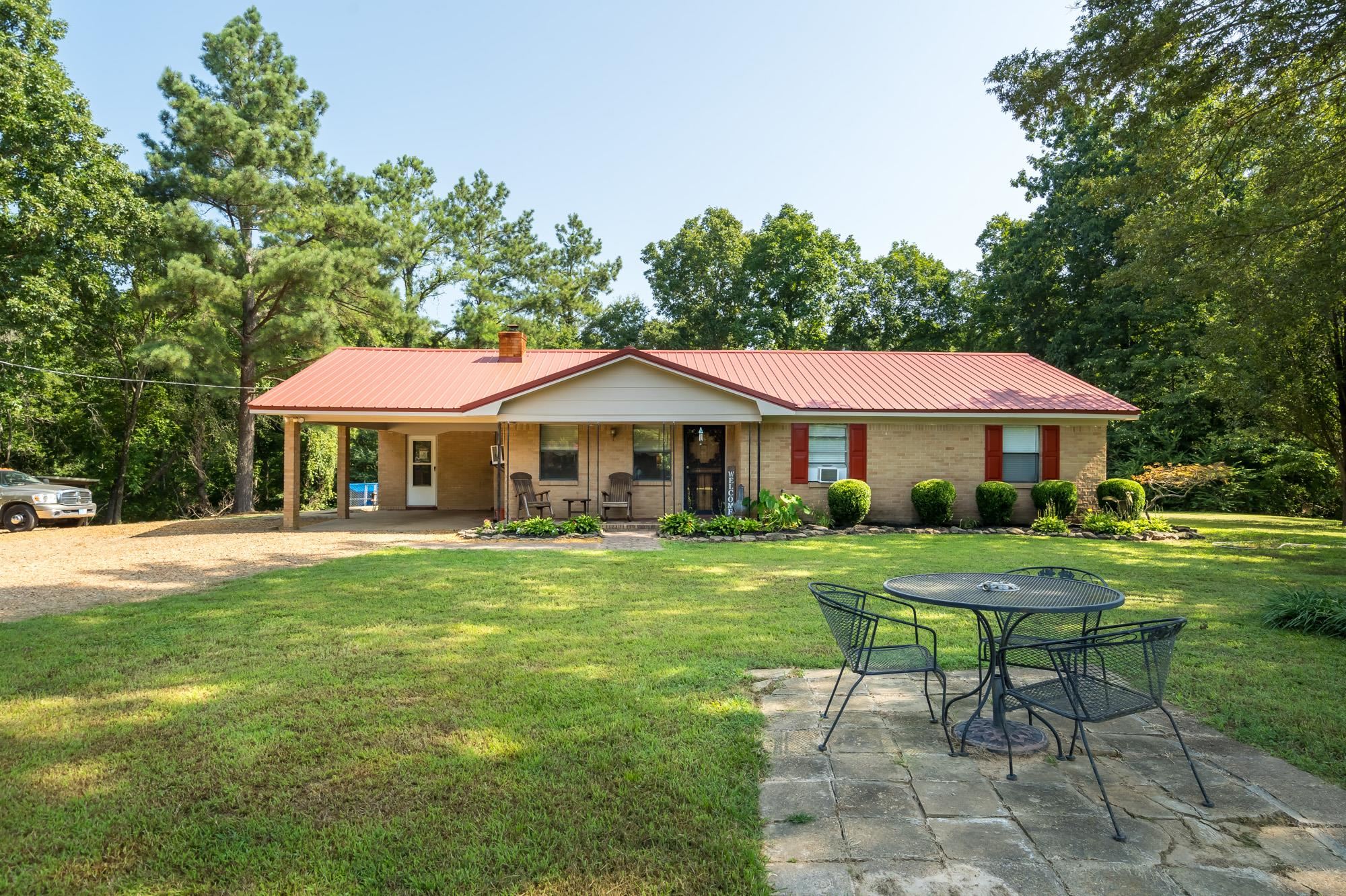 2484 Bryan Road Michigan City, MS 38647 - Photo 3 of 31 a front view of a house with swimming pool having outdoor seating