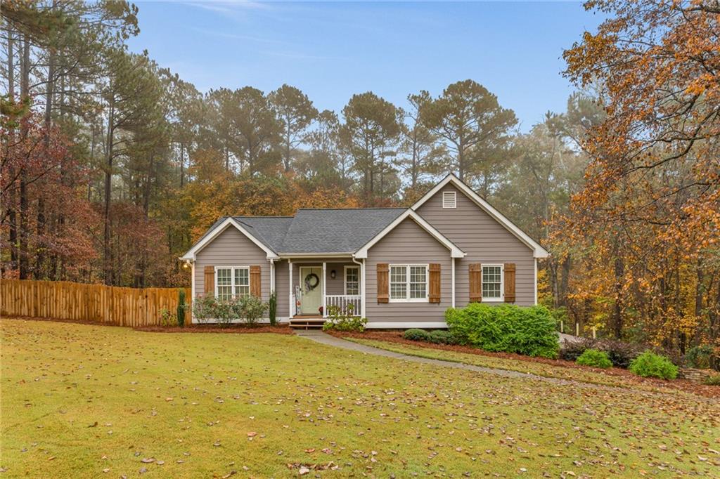 a front view of a house with a yard and trees