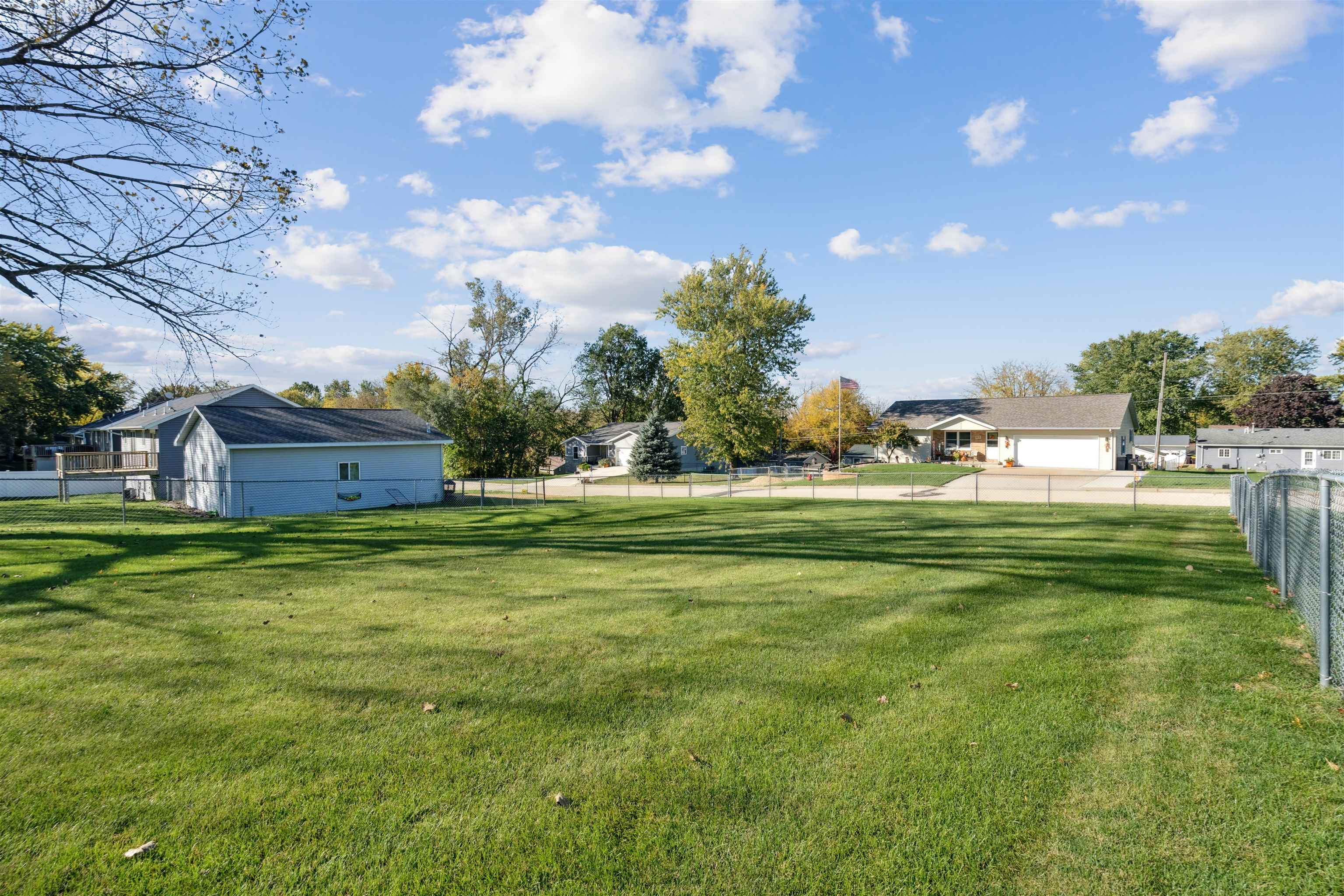 8920 Badger Road East Dubuque, IL 61025 - Photo 14 of 15 a backyard of a house with lots of green space and garden