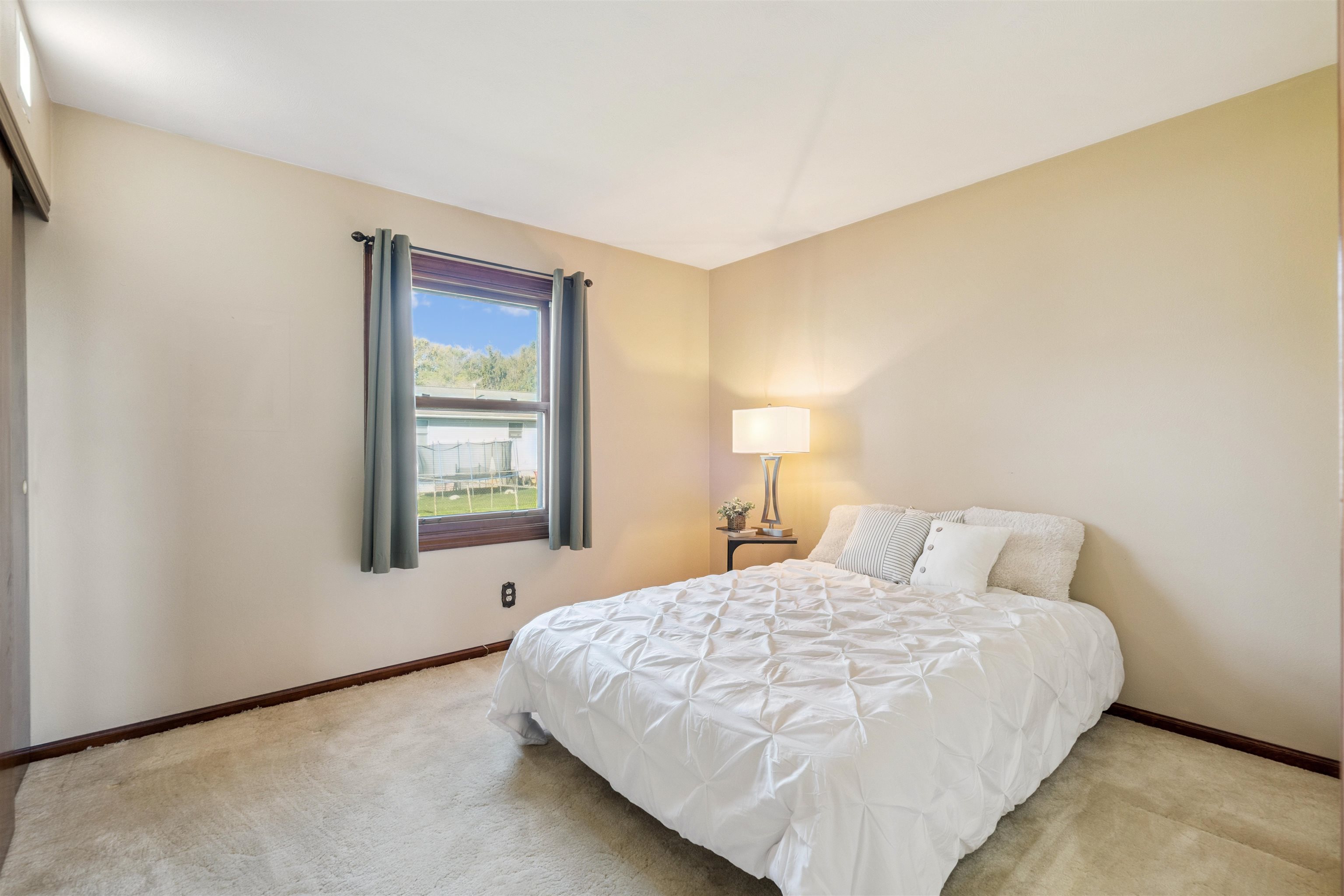8920 Badger Road East Dubuque, IL 61025 - Photo 7 of 15 a bedroom with a bed and a window