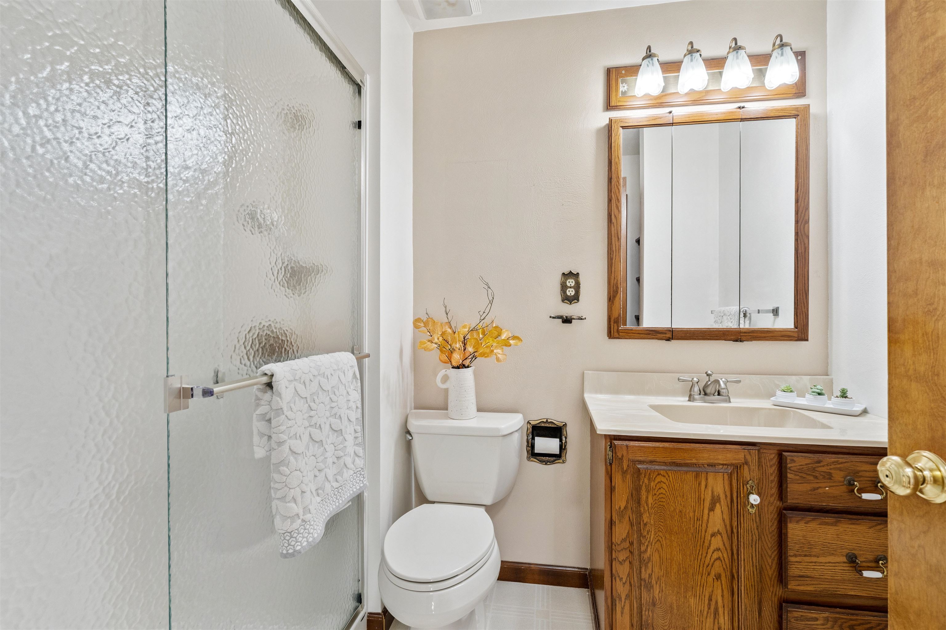 8920 Badger Road East Dubuque, IL 61025 - Photo 10 of 15 a bathroom with a sink vanity mirror and toilet