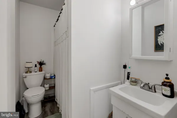 a bathroom with a toilet sink and mirror