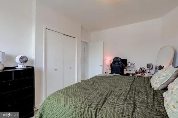 a bedroom with a bed and a closet