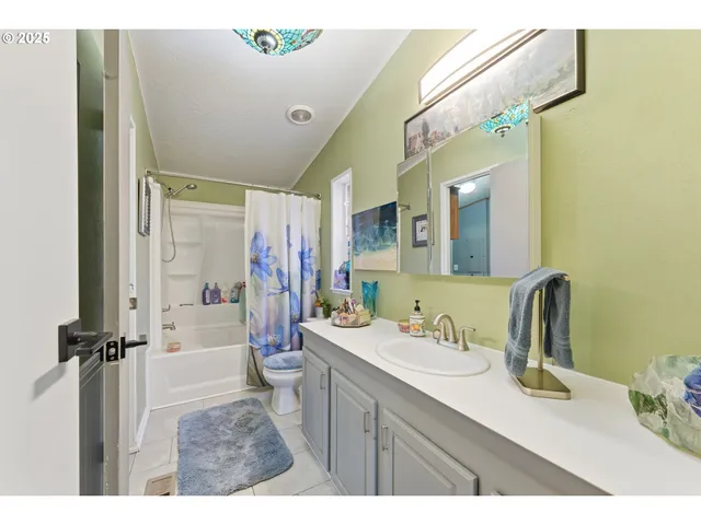 a bathroom with a sink mirror and a bathtub