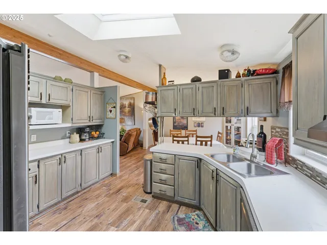 a kitchen with a sink and wooden cabinets