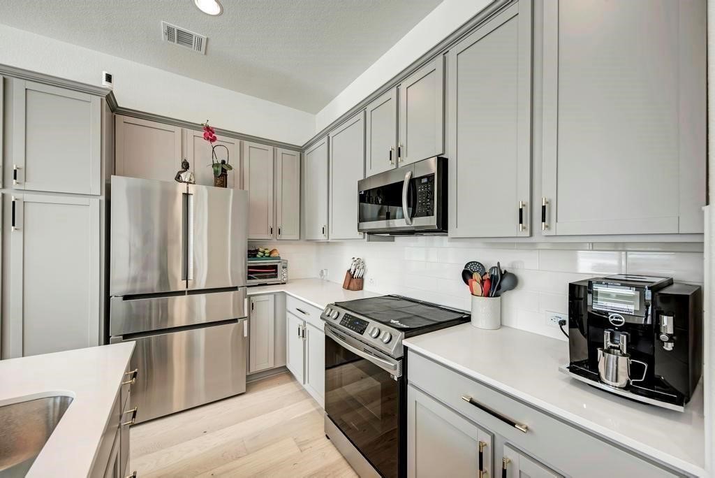 2050 Lohmans Spur Road, Unit 703 Lakeway, TX 78734 - Photo 7 of 14 All stainless steel appliances with Refrigerator, Washer and Dryer included