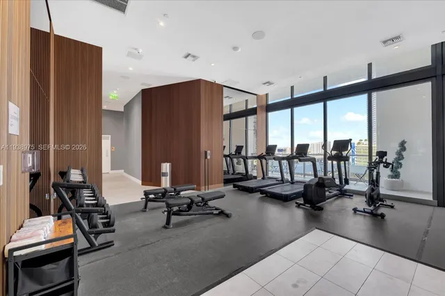 a bedroom with bed and a large mirror