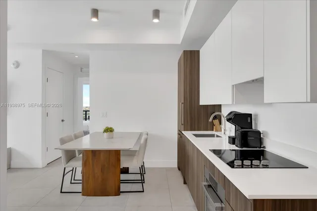 a kitchen with a sink and white cabinets