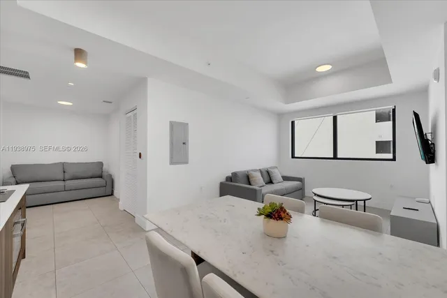 a living room with furniture and a sink