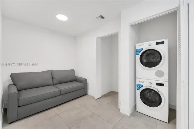 a bed sitting in a bedroom next to a large window