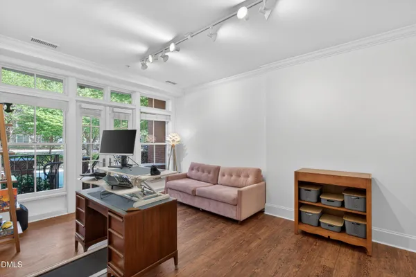 a living room with furniture a flat screen tv and a large window