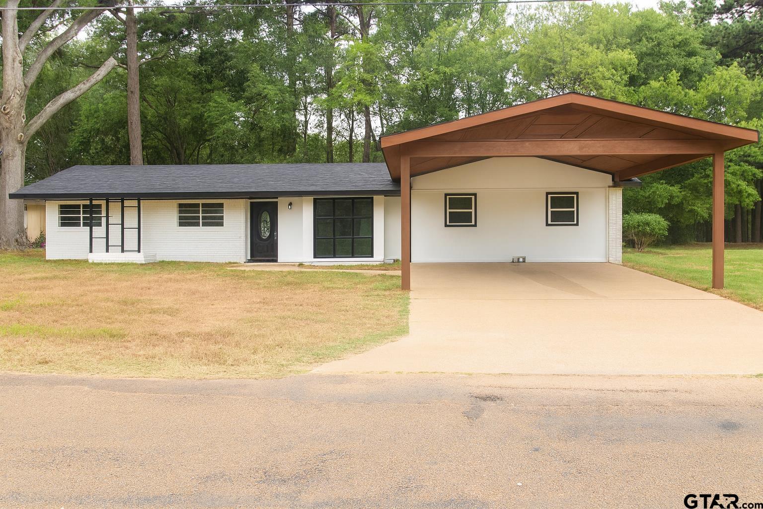 149 County Road 4237 Jacksonville, TX 75766 - Photo 1 of 19 a house with trees in the background