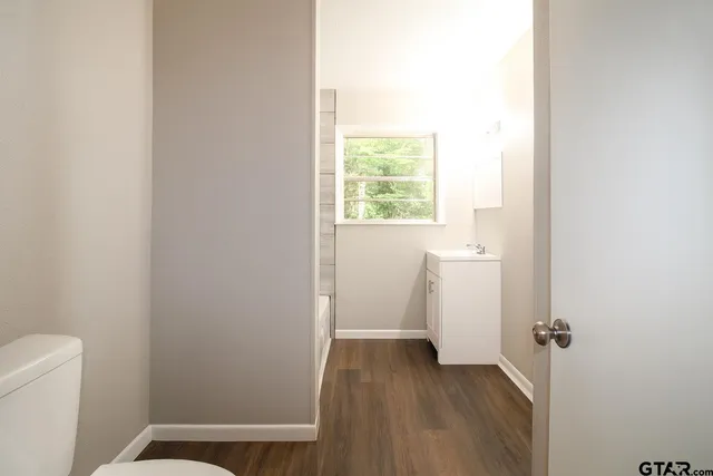 a view of a room with wooden floor
