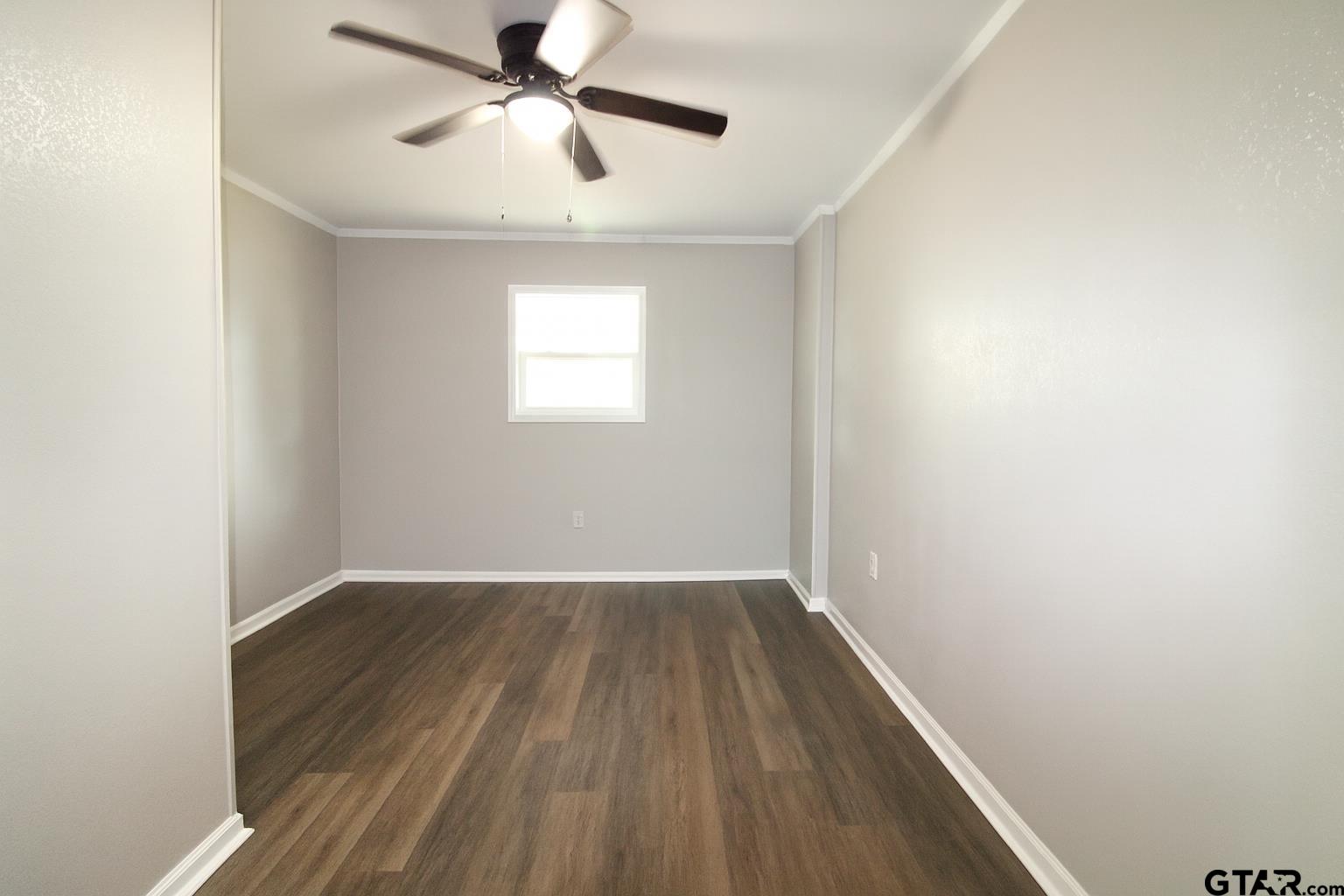 149 County Road 4237 Jacksonville, TX 75766 - Photo 17 of 19 wooden floor in an empty room with a window