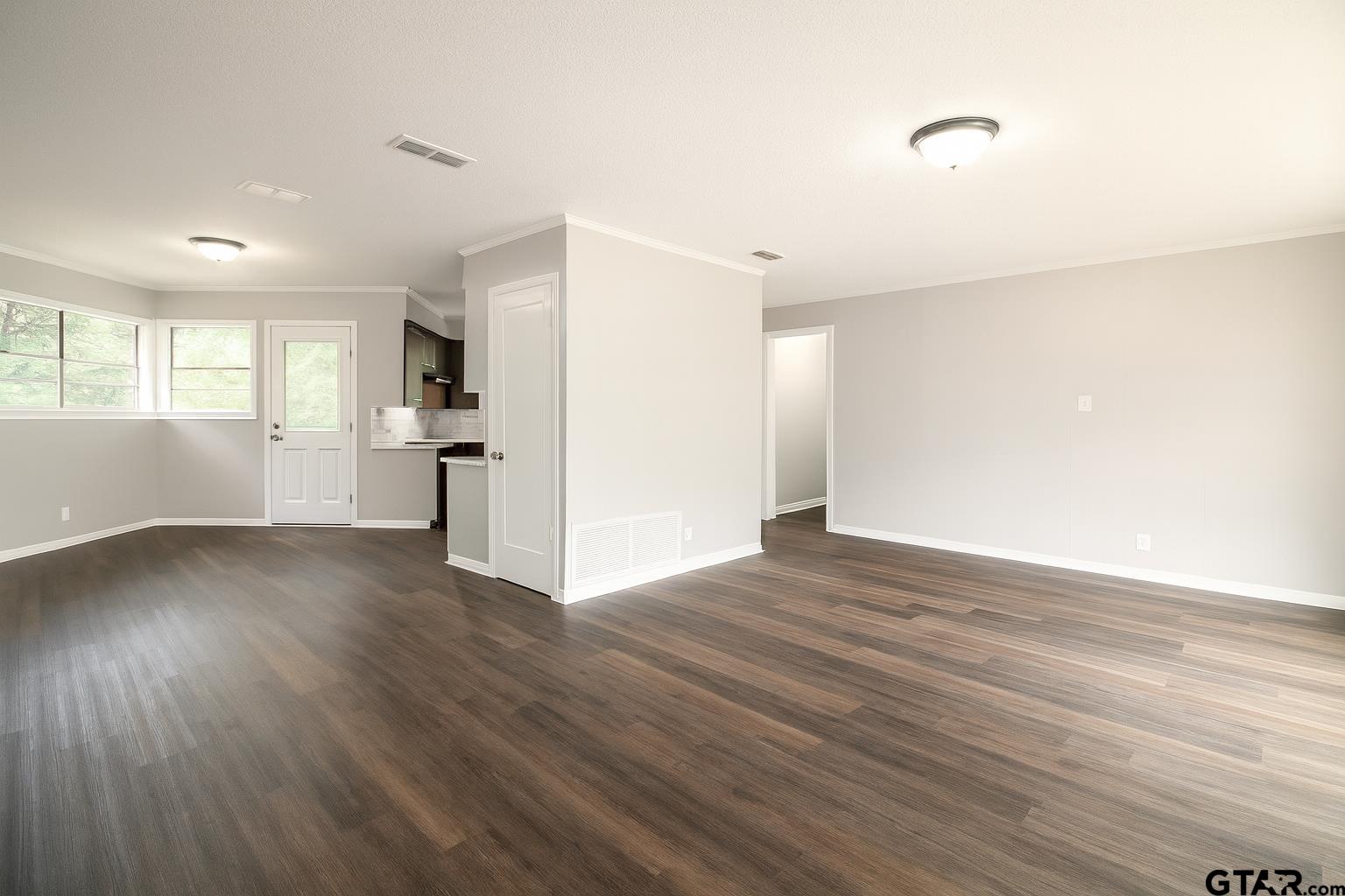 149 County Road 4237 Jacksonville, TX 75766 - Photo 5 of 19 a view of empty room with wooden floor and window