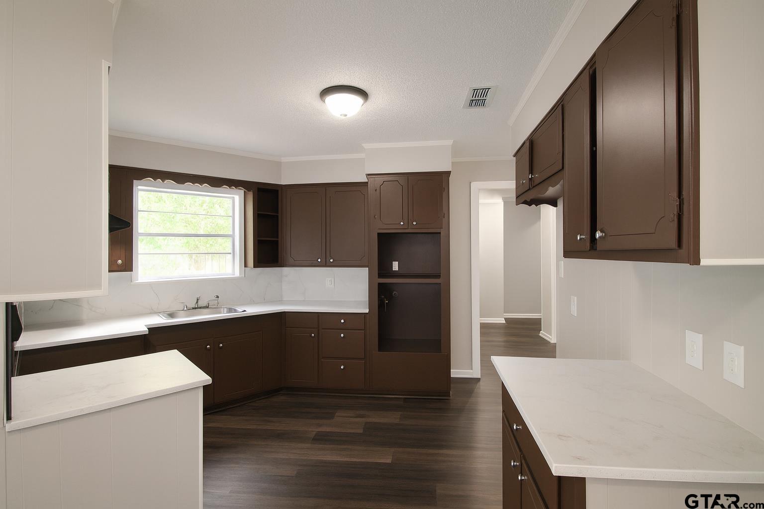 149 County Road 4237 Jacksonville, TX 75766 - Photo 6 of 19 a kitchen with granite countertop a sink a stove and refrigerator