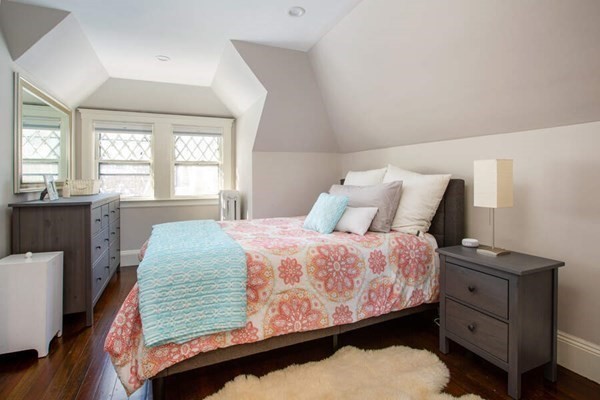 69 Evans Road Brookline, MA 02445 - Photo 15 of 24 a bedroom with a bed a dresser and a window