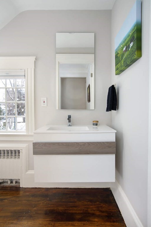 69 Evans Road Brookline, MA 02445 - Photo 22 of 24 a bathroom with a sink and a mirror