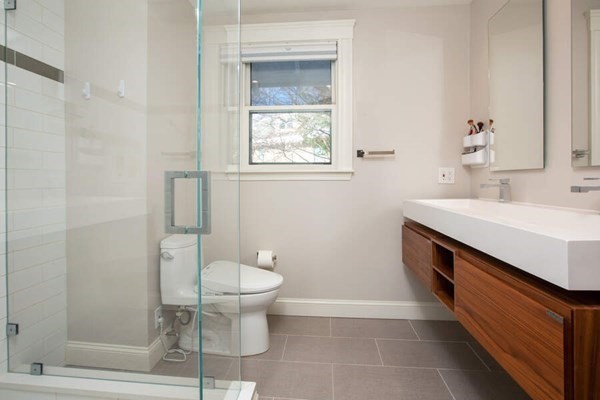 69 Evans Road Brookline, MA 02445 - Photo 23 of 24 a bathroom with a sink toilet and a mirror