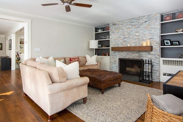 69 Evans Road Brookline, MA 02445 - Photo 5 of 24 a living room with furniture and a fireplace