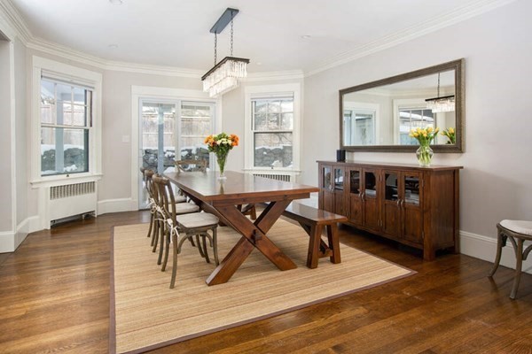 69 Evans Road Brookline, MA 02445 - Photo 6 of 24 a view of a dining room with furniture and wooden floor