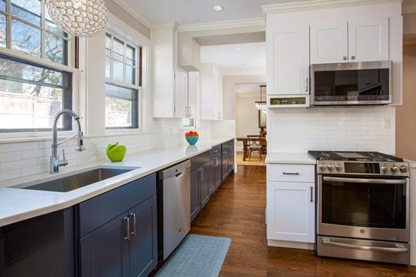 69 Evans Road Brookline, MA 02445 - Photo 7 of 24 a kitchen with stainless steel appliances a sink a stove and cabinets