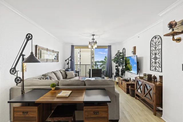 a living room with furniture a rug and a flat screen tv