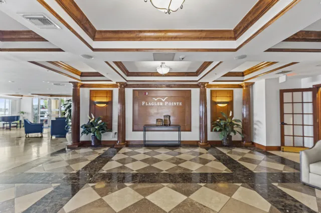 a living room with a large window and chandelier